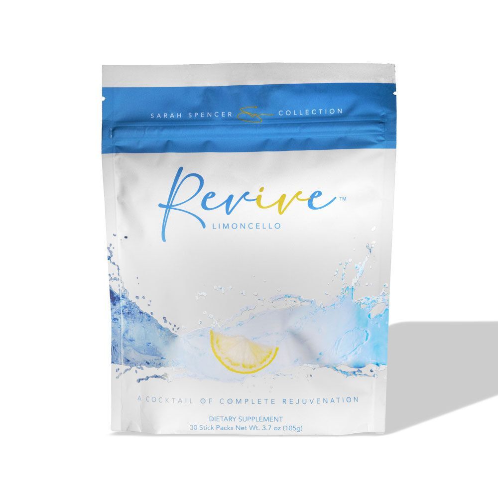 White packaging for "Revive Limoncello" dietary supplement, featuring splashes of water and a lemon slice. Top blue band reads "Sarah Spencer Collection."