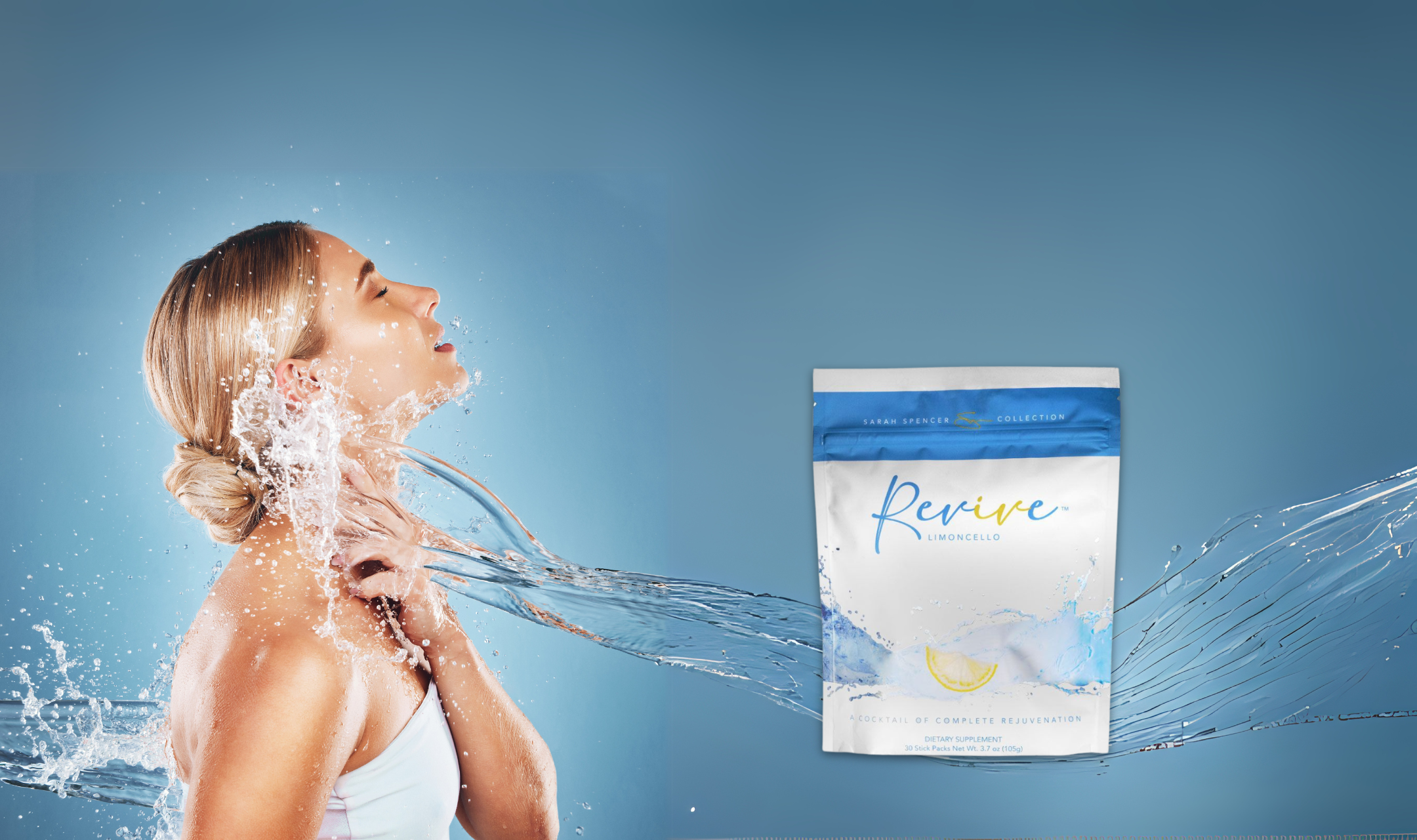 A woman with closed eyes leans back as water splashes over her in a refreshing scene. Beside her is a "Revive" Limoncello product packet. The mood is rejuvenating.